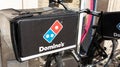 Dominos pizza logo and text sign on delivery bike bag case for restaurant Domino`s