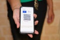 European sanitary pass with QR code on a smartphone screen in hand
