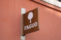 faguo shop sign text and brand logo wall facade clothes store more circular less