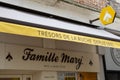 Famille Mary logo text store and brand bee sign on entrance facade wall boutique