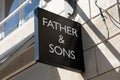 Father & Sons logo text wall facade and shop brand sign front entrance store brand Royalty Free Stock Photo