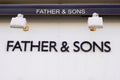 Father & Sons wall facade brand logo text sign on entrance  store German luxury Royalty Free Stock Photo