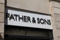 Father & Sons wall facade entrance brand logo with text sign entrance facade store Royalty Free Stock Photo