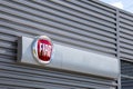 Fiat logo sign car store showroom dealership text brand on station facade wall garage