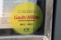 Gault & Millau logo brand and text sign yellow nameplate board of influential French