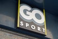 Go Sport sign text and brand logo on entrance windows wall of store sporty Company