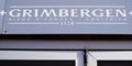 Grimbergen beer sign and text logo on restaurant bar wall Belgian abbey beers