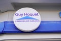 Guy hoquet logo and text sign front wall facade office of real estate brand french