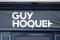 Guy hoquet logo and text sign front wall facade office of real estate brand french