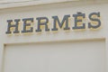 Hermes logo and text sign front of shop entrance of French high fashion store luxury