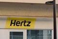 Hertz logo brand and text sign of American car rental company with international Royalty Free Stock Photo