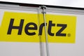 Hertz logo brand and text sign of American car rental company on rear truck panel van