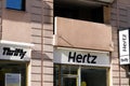 Hertz logo brand and text sign wall entrance of American car rental company with Royalty Free Stock Photo