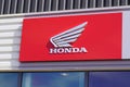 Honda dealership logo brand wing and text sign front of motorbike store Japanese Royalty Free Stock Photo