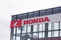 Honda motorcycle wing logo and red text sign front of dealership store motorbike Royalty Free Stock Photo