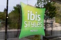 Ibis styles pillow green sign logo hotel text brand on door window building entrance