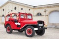 Jeep military wwII red vintage old timer car parked in city street Royalty Free Stock Photo