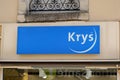 Krys optic logo blue and text sign front of optician shop glass optic store brand