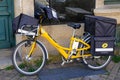 La Poste postman bike in French city with logo sign and brand text of France post