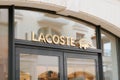 Lacoste logo and golden sign front of store french chain of luxury polo sport clothes