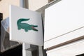 Lacoste sign store logo front of French boutique fashion clothing company shop