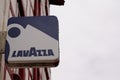 Lavazza logo and sign of coffee shop advertising front of bar building facade and