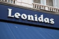 Leonidas logo brand and sign text entrance wall blue facade shop entrance of Belgian