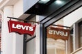 Levi`s logo red sign and text front of Jeans levis store of clothing fashion levi