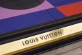 Louis Vuitton logo text and golden brand sign store street luxury facade fashion shop