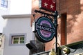 Magners Irish Cider logo brand and text sign advertising on wall facade pub bar