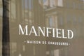 Manfield boutique shop shoes retailer sign logo and brand text store