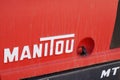 Manitou logo brand and text sign on nacelle four wheel drive forklift tractor