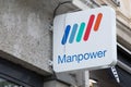 manpower sign text and logo brand on chain facade wall of employment staffing firm