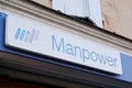 Manpower sign text and logo front of employment staffing firm agency