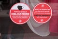 Masque obligatoire and safety distance anti covid-19 french text sign on windows shop