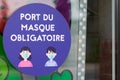 Masque obligatoire text French means face mandatory mask required in door entrance