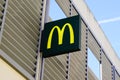Mcdonald`s logo and text sign on facade of american brand of fast food restaurant