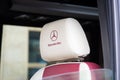 mercedes benz logo brand and text sign on car headrest white leather red