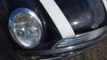 Mini cooper car headlight and logo front hood model produced by BMW German luxury Royalty Free Stock Photo