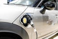 Mini E electric car charged parked detail in side charger modern hybrid vehicle ev