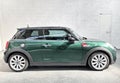 Mini modern car in racing green color side view in dealership interior of cooper Royalty Free Stock Photo