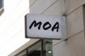 moa logo brand and text sign on wall facade storefront fashion business