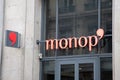 Monop\' chain Monoprix logo sign and brand text on wall entrance shop supermarket stor