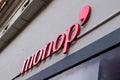 Monop` logo sign brand on city building of supermarket facade in town street