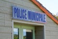 Municipal police facade wall logo and text sign on entrance official building of mayor