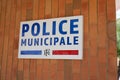 Municipal police facade wall logo and text sign on entrance facade official building