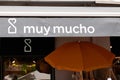 Muy mucho logo brand and text sign boutique facade