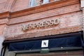 Nespresso brand logo and text sign of shop specialised in coffee machines capsules and Royalty Free Stock Photo