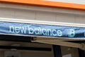 New Balance logo and text sign on shop entrance official store of sportswear shoes