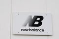 New Balance logo and text sign on white facade shop entrance official store of